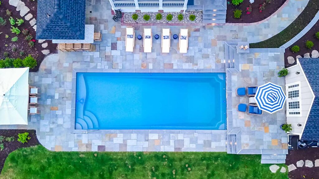 Aerial View Of Pool With Tanning Ledge & Diving End